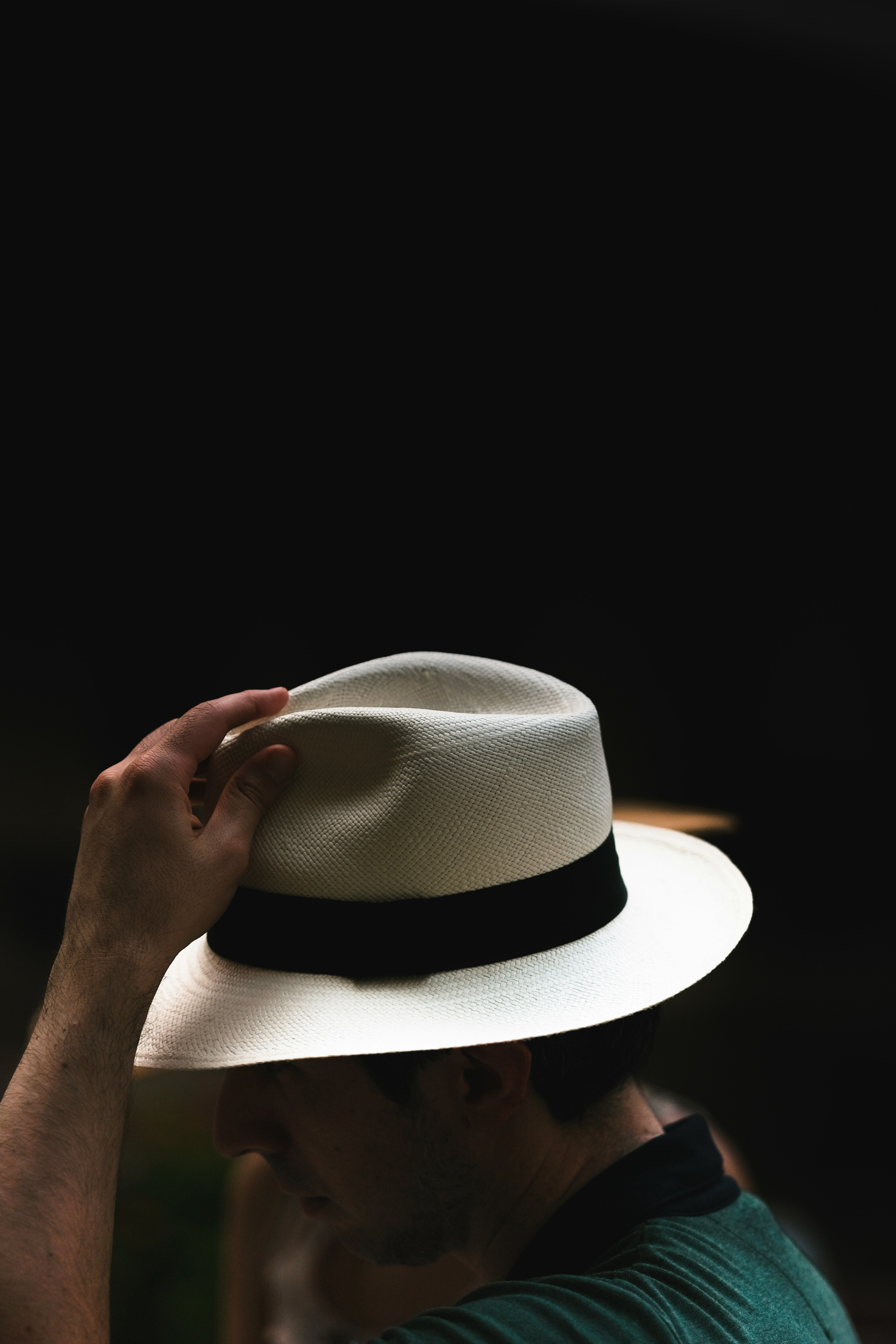 person wearing white fedora hat
